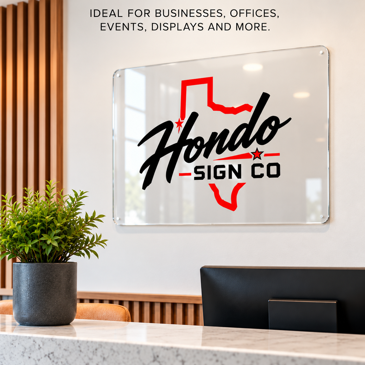 Custom clear acrylic business sign displayed in a modern office reception area